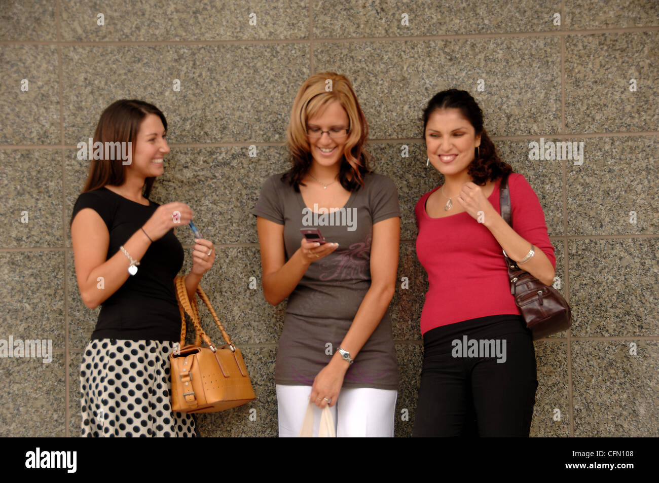 Women Leaning Against Wall Outside Stock Photo Alamy