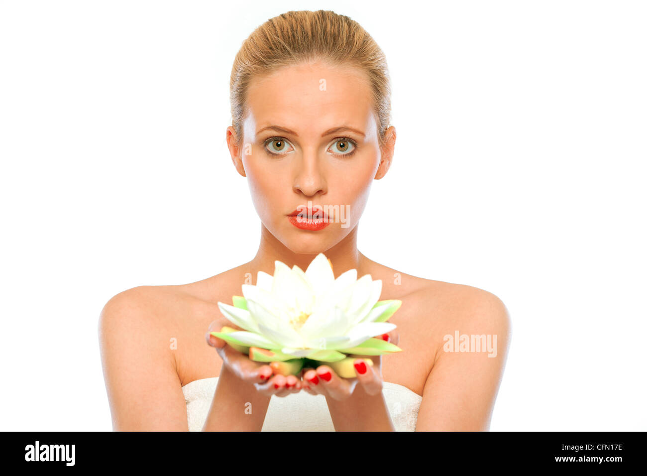 Young beautiful woman holding lotus flower in hands isolated on white