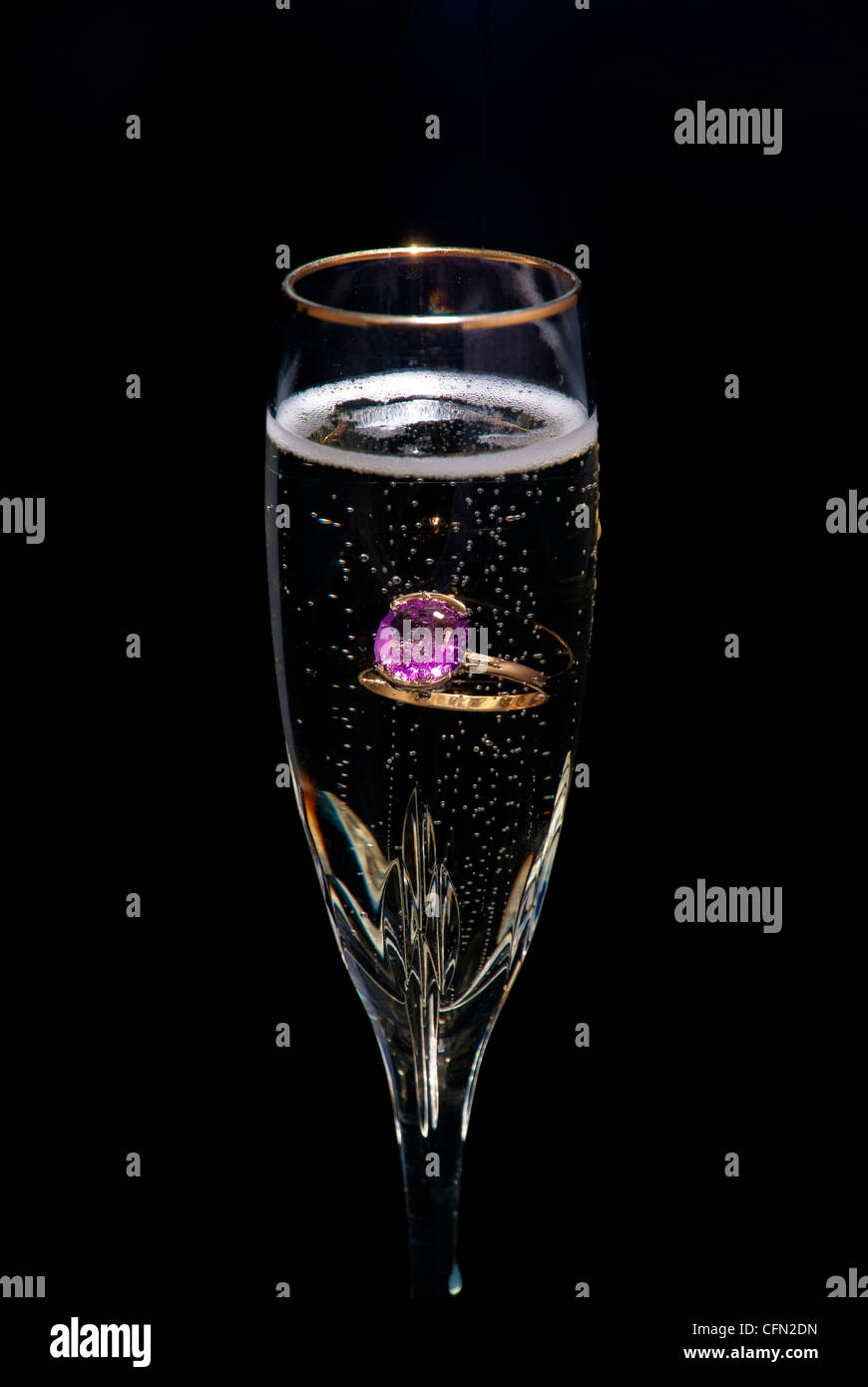 Glass of Champagne with a ring in it Stock Photo
