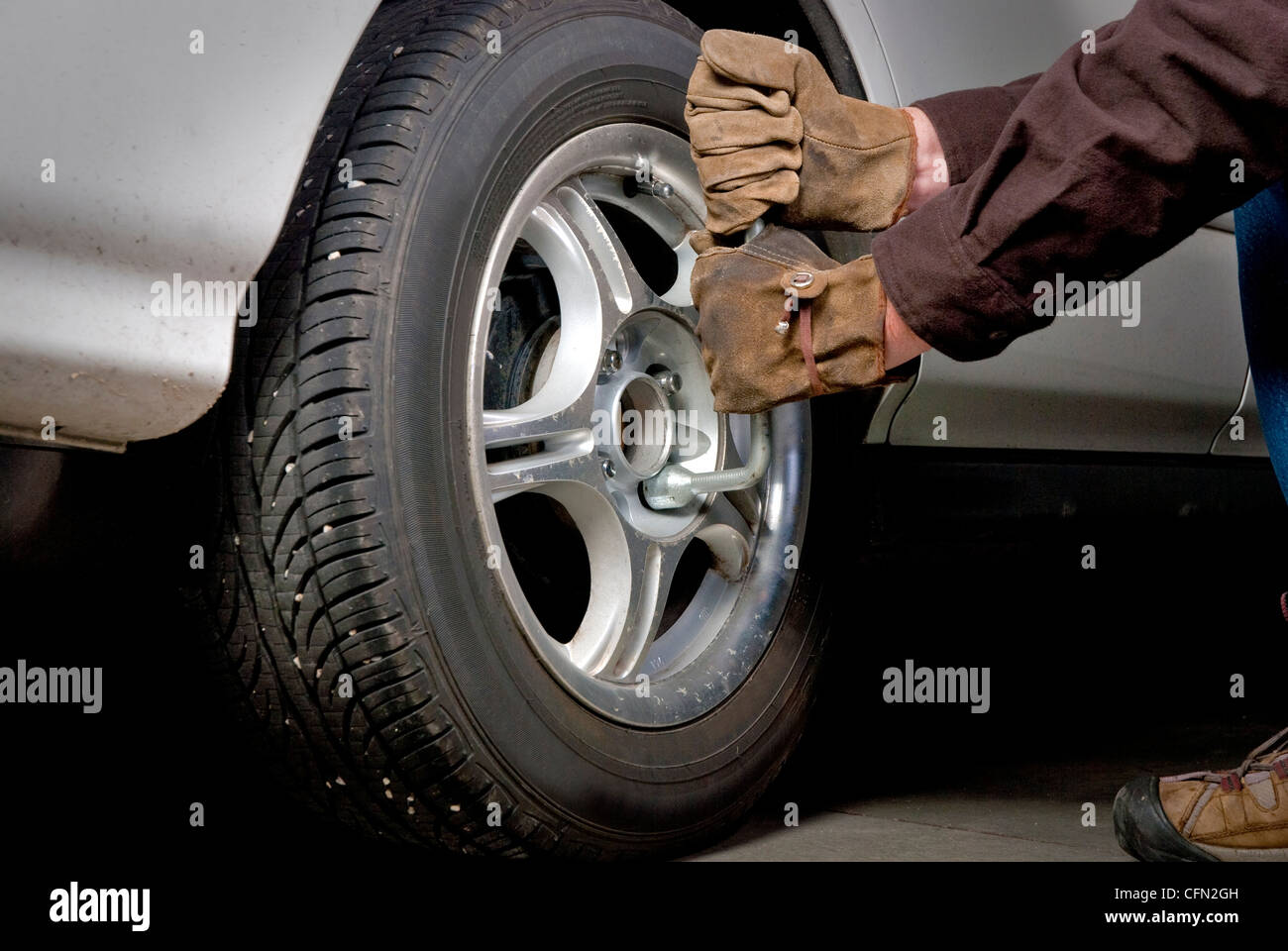 Lug Nuts are removed so that a tire can be replaced Stock Photo