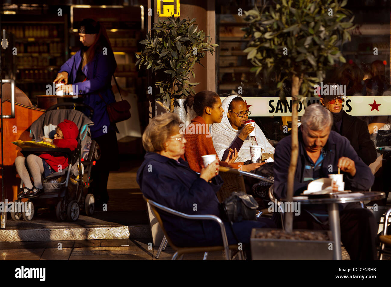 People enjoying a coffee outside on King street, Hammersmith Stock