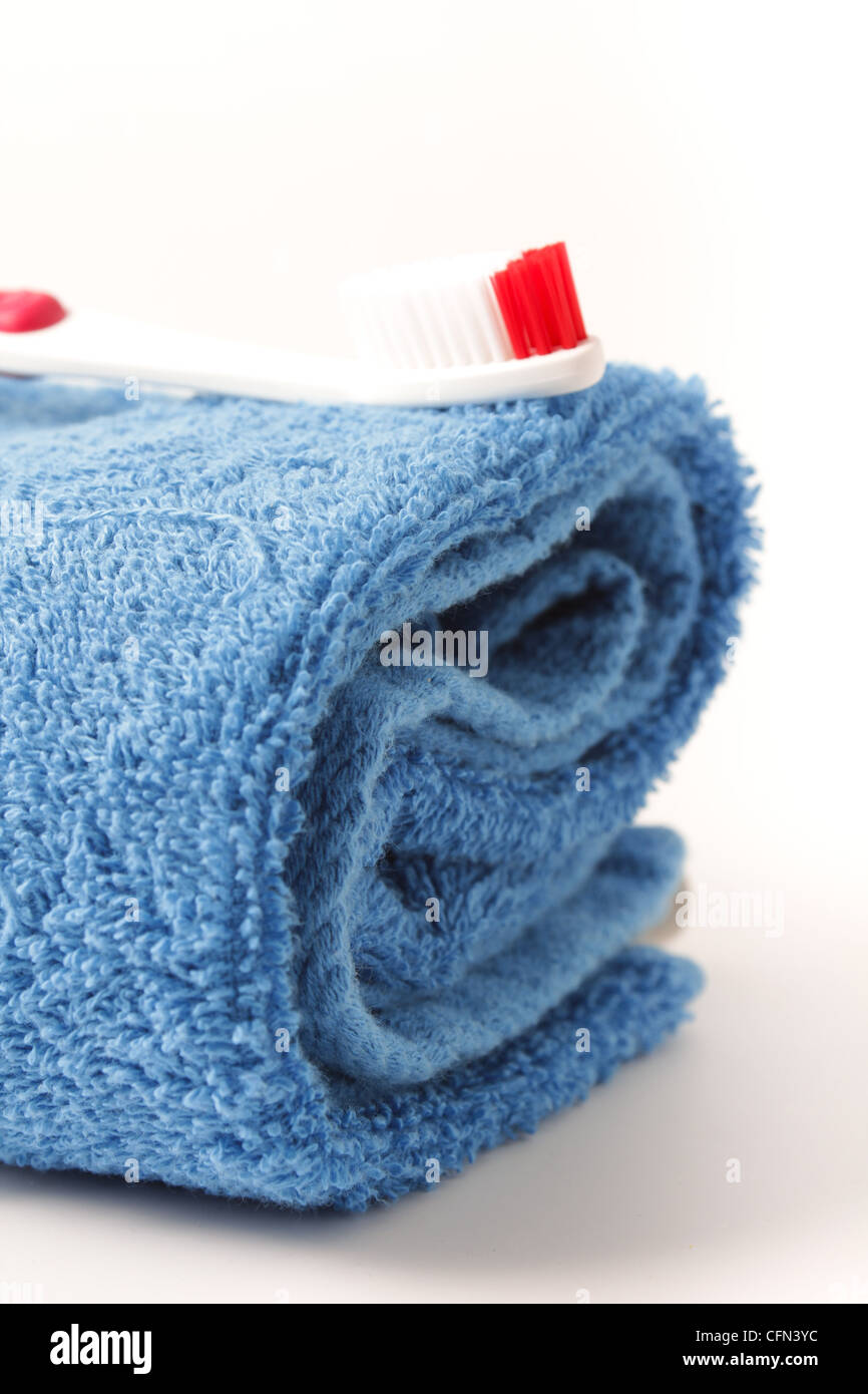 Cotton towel with toothbrush Stock Photo