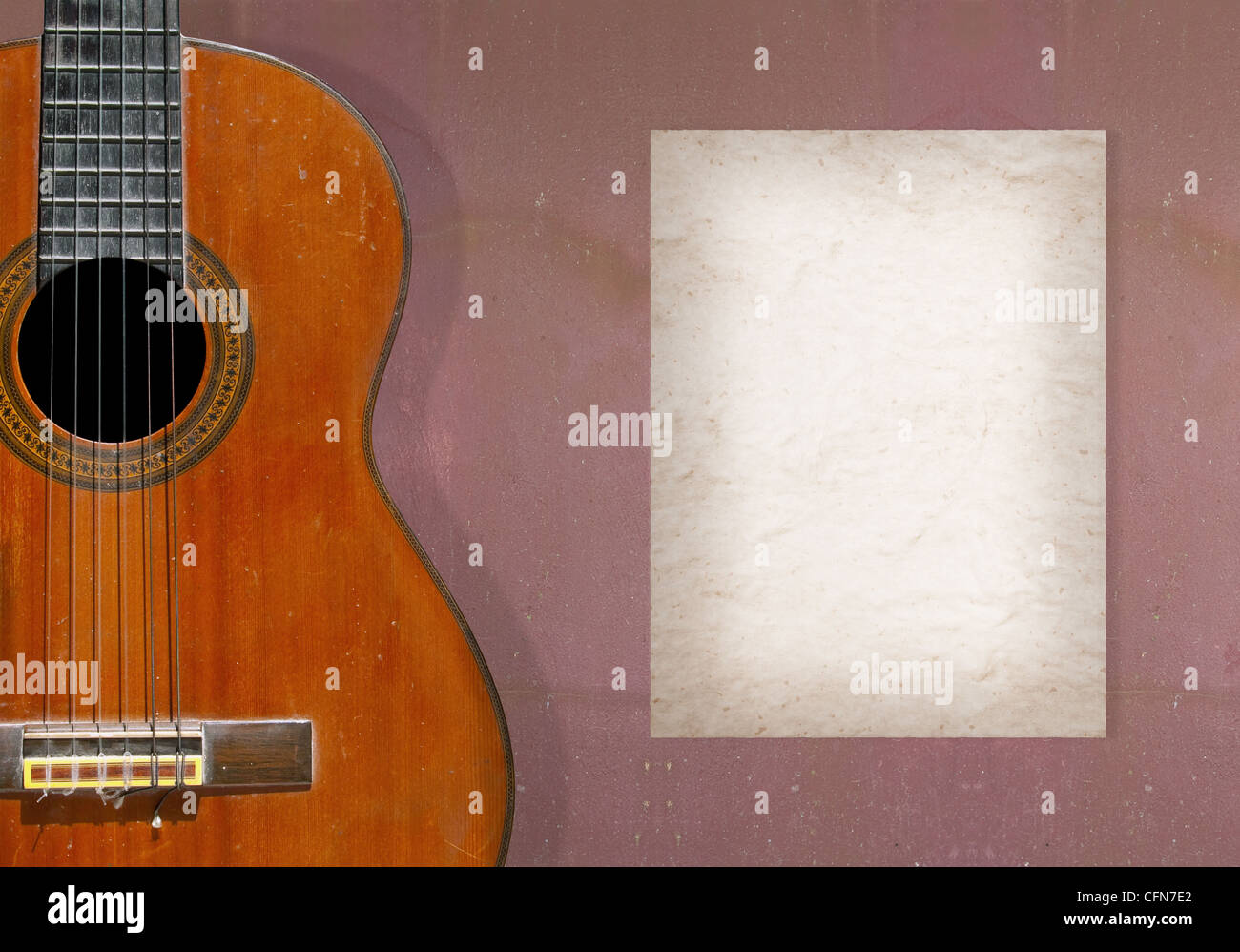 Classical guitar on grunge wall with blank page of mulberry paper Stock Photo