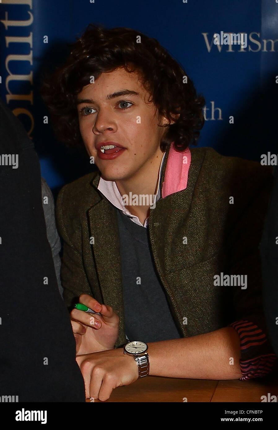 Harry Styles One Direction promoting and signing copies of their new book 1D One Direction Forever Young at WH Smiths in Birmingham. WH Smiths reported that the wrist bands sold to