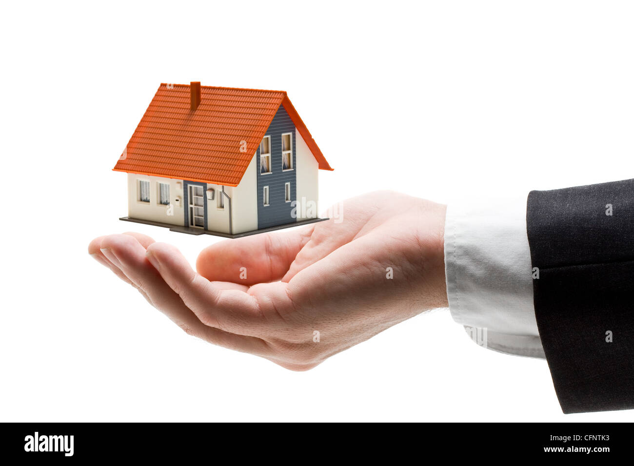Businessman hand with model house - home concept Stock Photo - Alamy