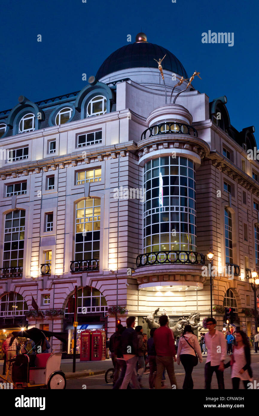 Modern architecture building at dusk, in Piccadily Circus corner with Haymarket St. and Leicester Sq.,   London, England, UK Stock Photo