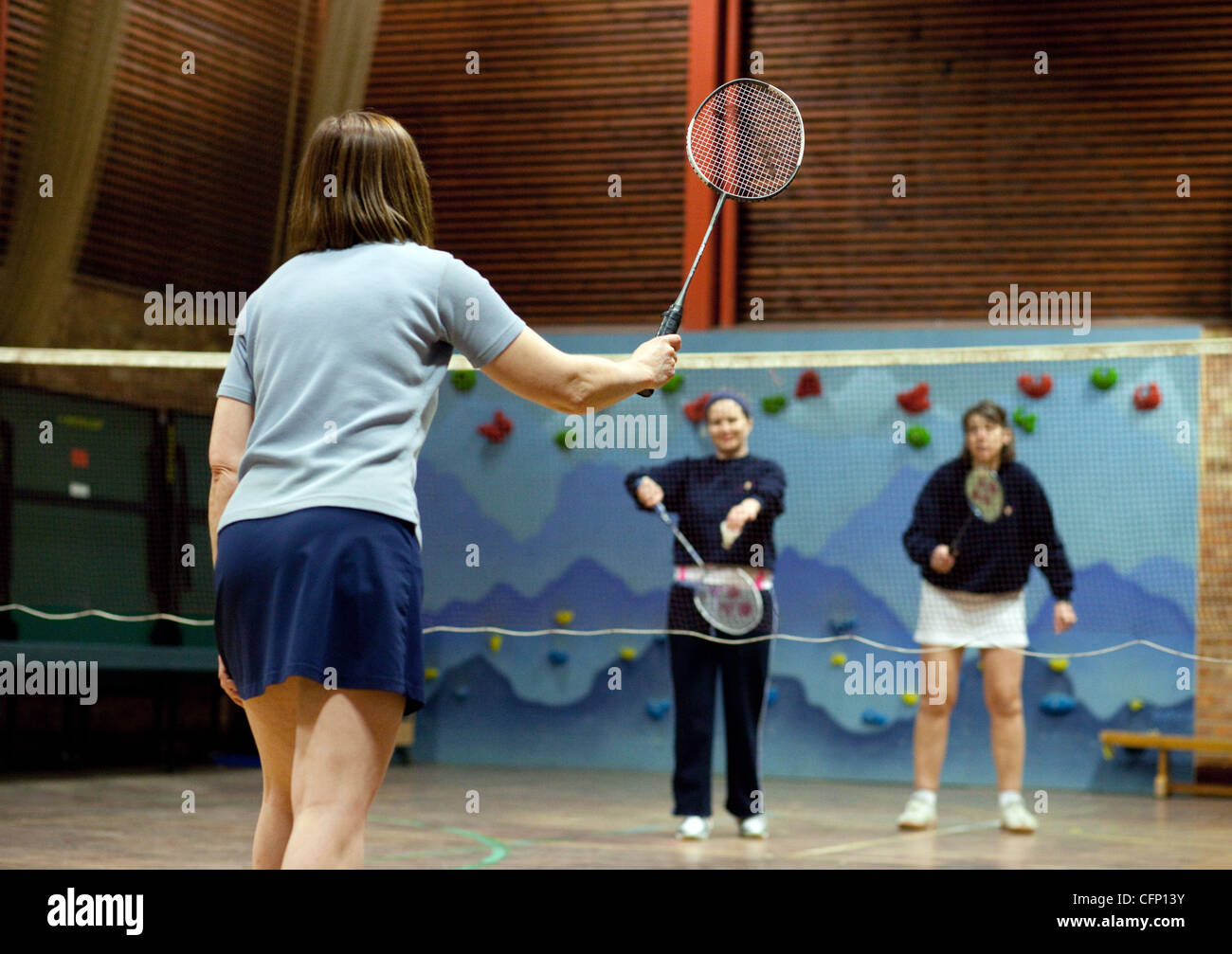 Women playing badminton indoors at their local club, Newmarket Suffolk UK Stock Photo