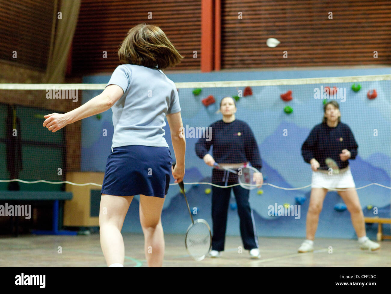 Women playing badminton indoors at their local club, Newmarket Suffolk UK Stock Photo