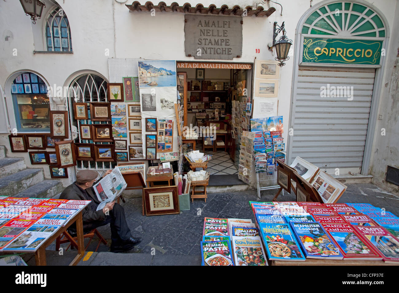 Man reading newspaper at book shop, Piazza Flavio Gioia, Amalfi, Amalfi coast, Unesco World Heritage site, Campania, Italy, Mediterranean sea, Europe Stock Photo