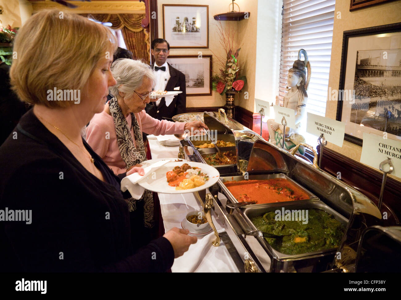 People serving themselves food in the Tamasha Indian restaurant