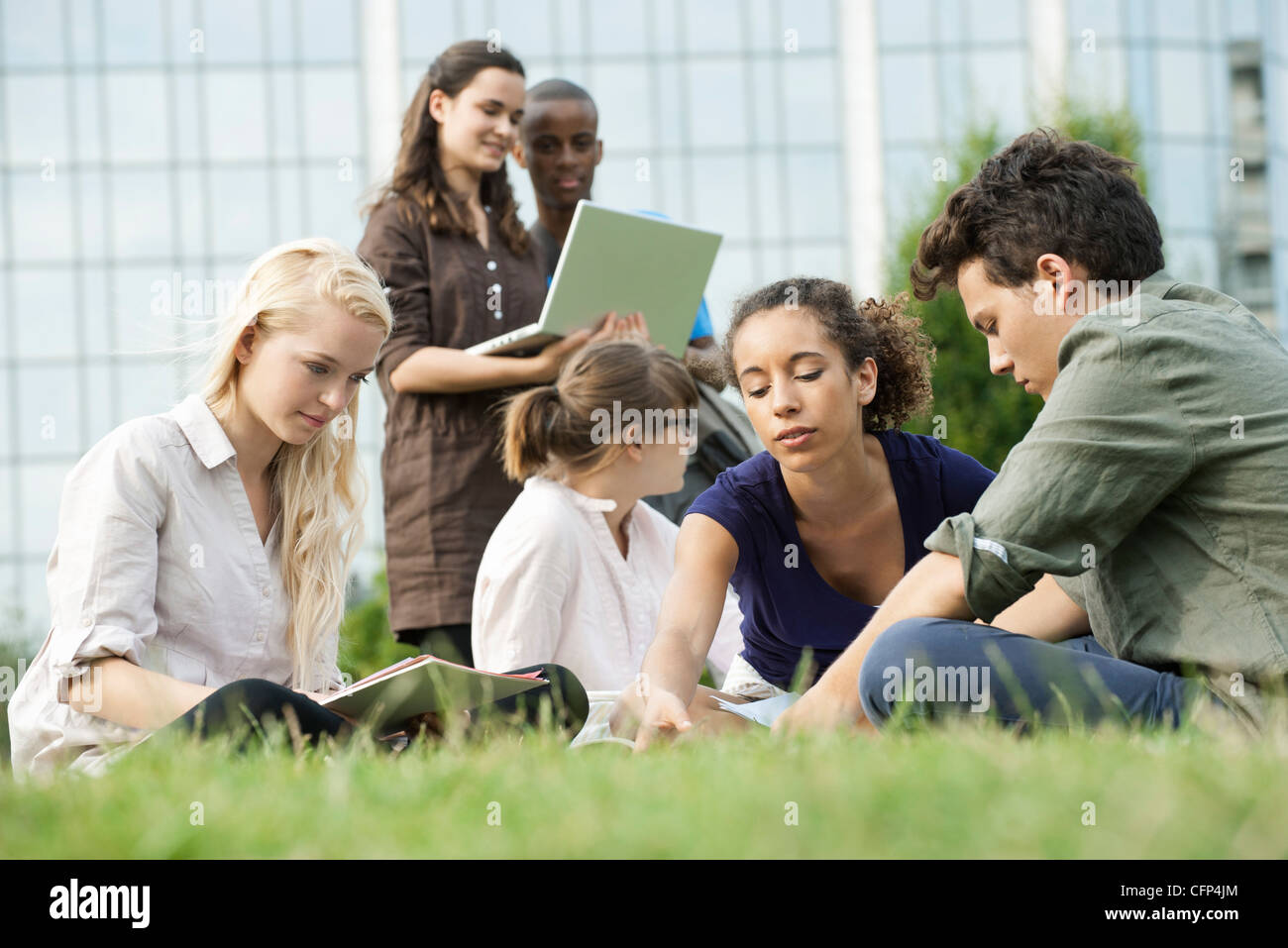 University students studying together outdoors, low angle view Stock Photo