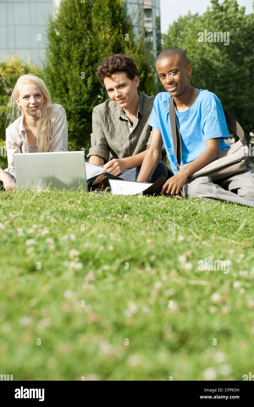 University students studying together on grass, low angle view Stock Photo