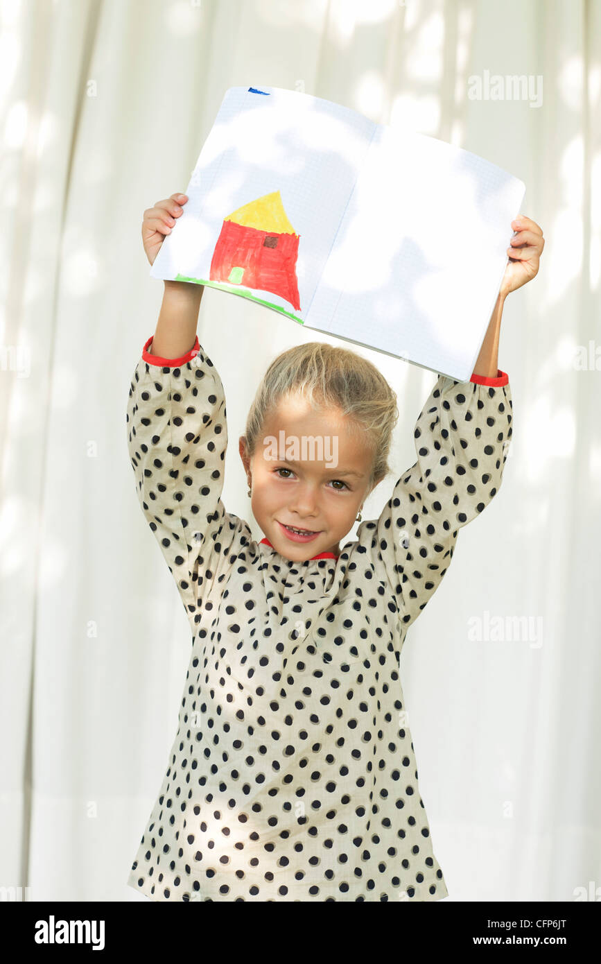 Little girl showing off drawing, portrait Stock Photo