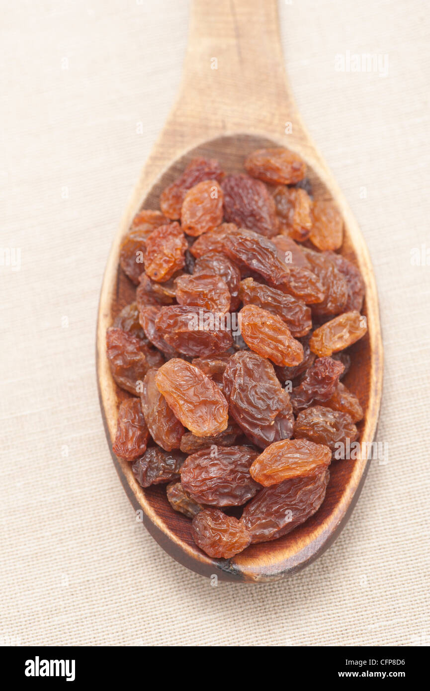 Raisins on a wooden spoon (sultanas) Stock Photo