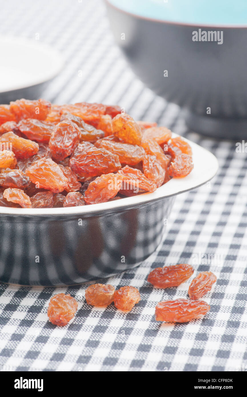 Bowl filled with raisins (sultanas) Stock Photo