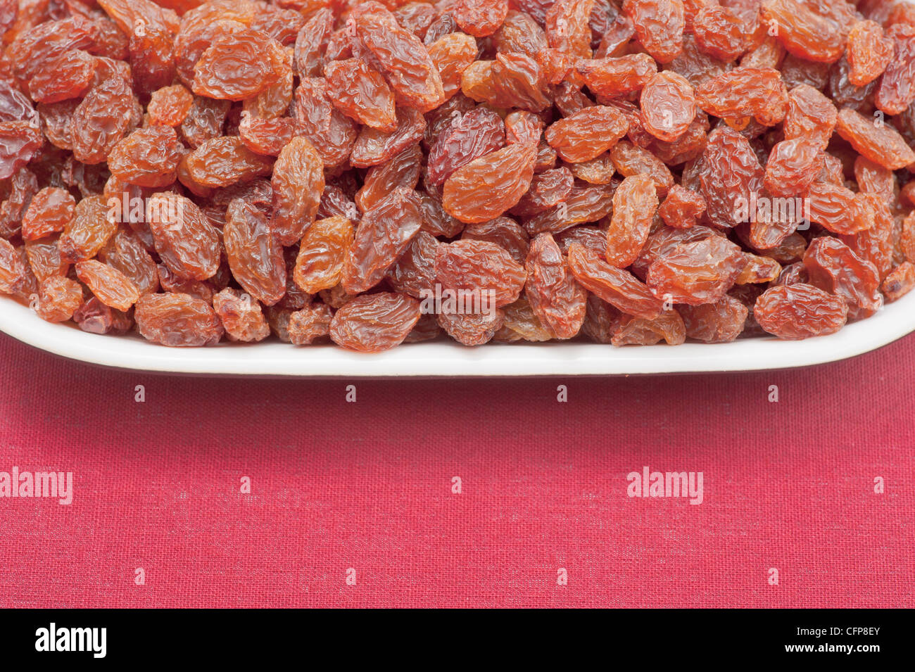 Plate filled with raisins (sultanas) Stock Photo