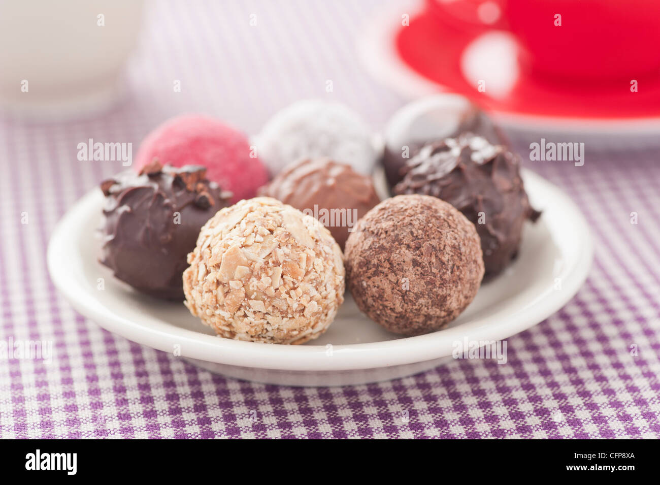 Closeup of assorted chocolate truffles on a plate Stock Photo