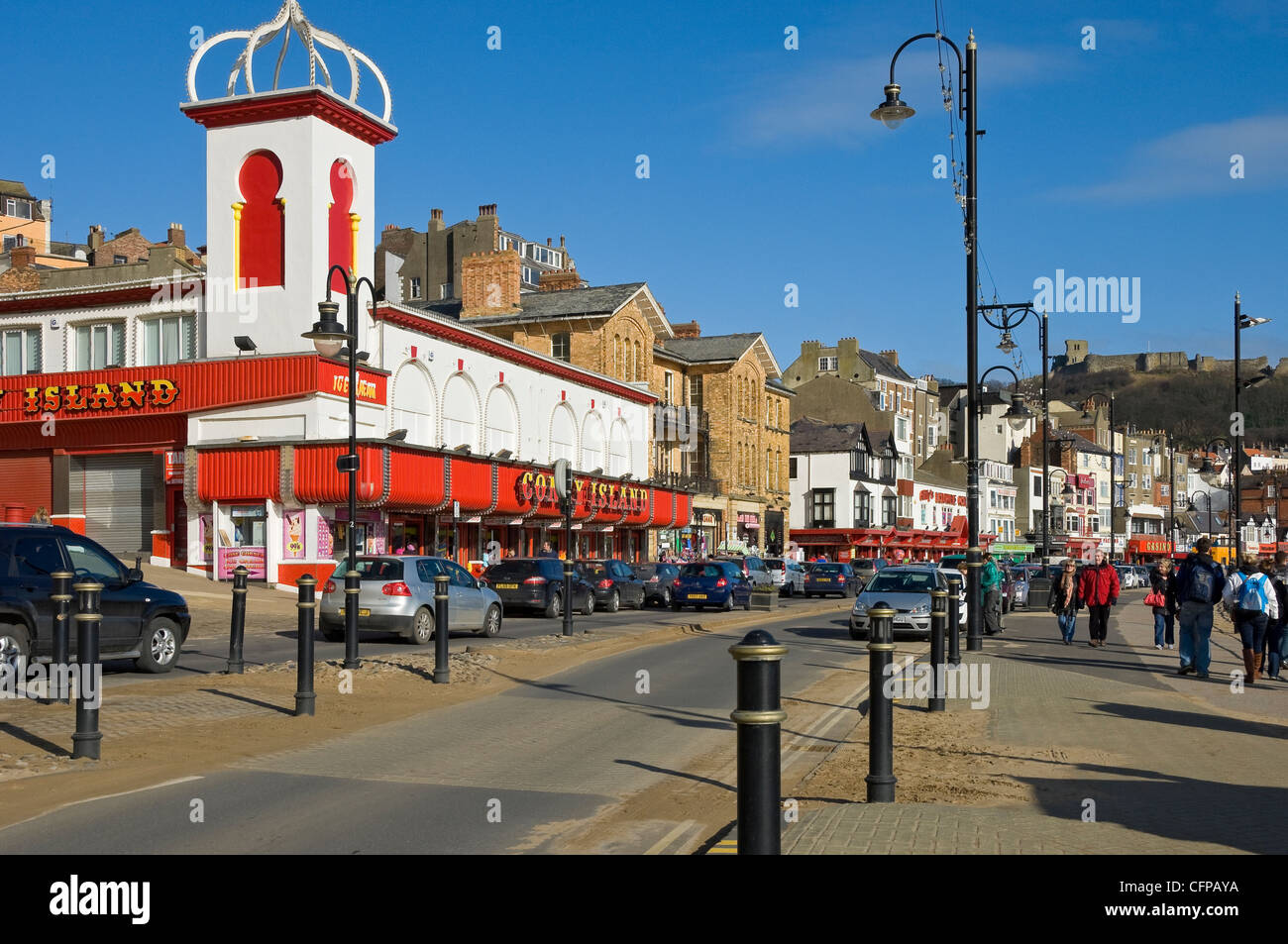 People visitors walking along the seafront and amusements in winter Foreshore Road Scarborough North Yorkshire England UK United Kingdom Great Britain Stock Photo