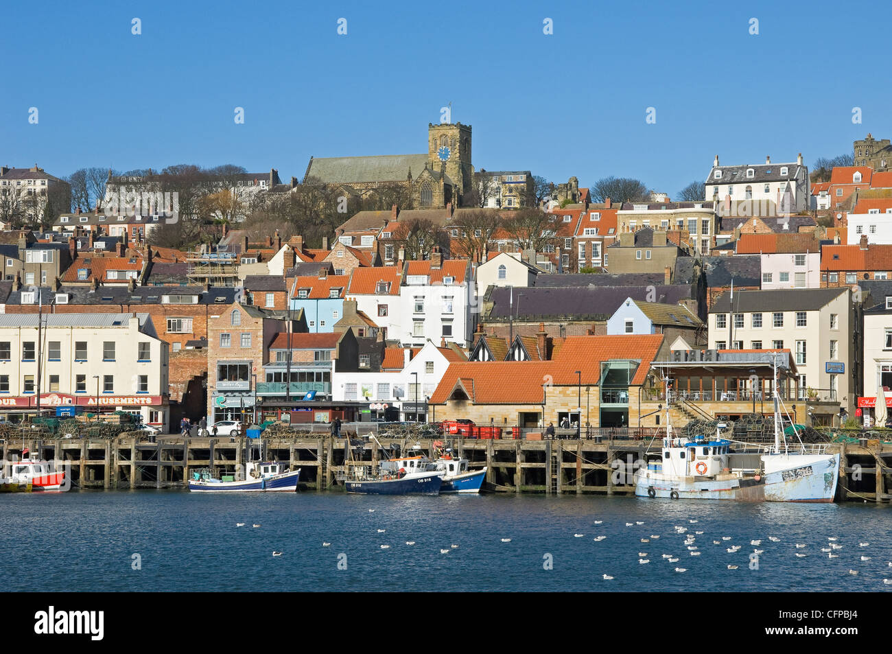 View looking towards the town and fishing boats in winter Scarborough seaside resort Harbour North Yorkshire England UK United Kingdom Great Britain Stock Photo
