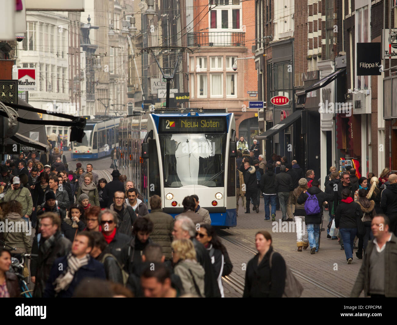a crowded Leidsestraat shopping street, Amsterdam the Netherlands with passing tram line 2 Stock Photo
