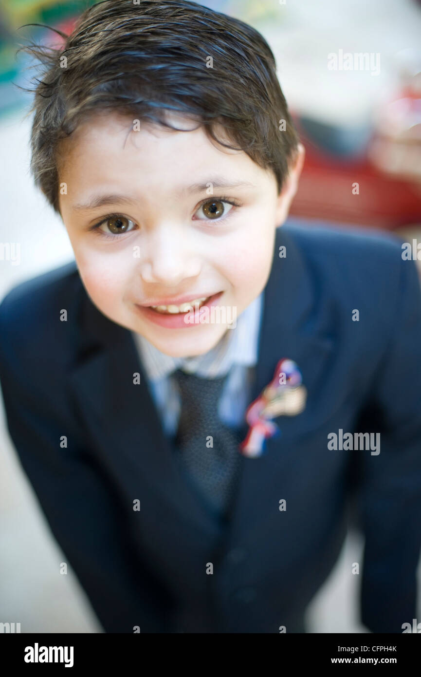 Five year old Hispanic boy formally dressed as a political candidate Stock Photo