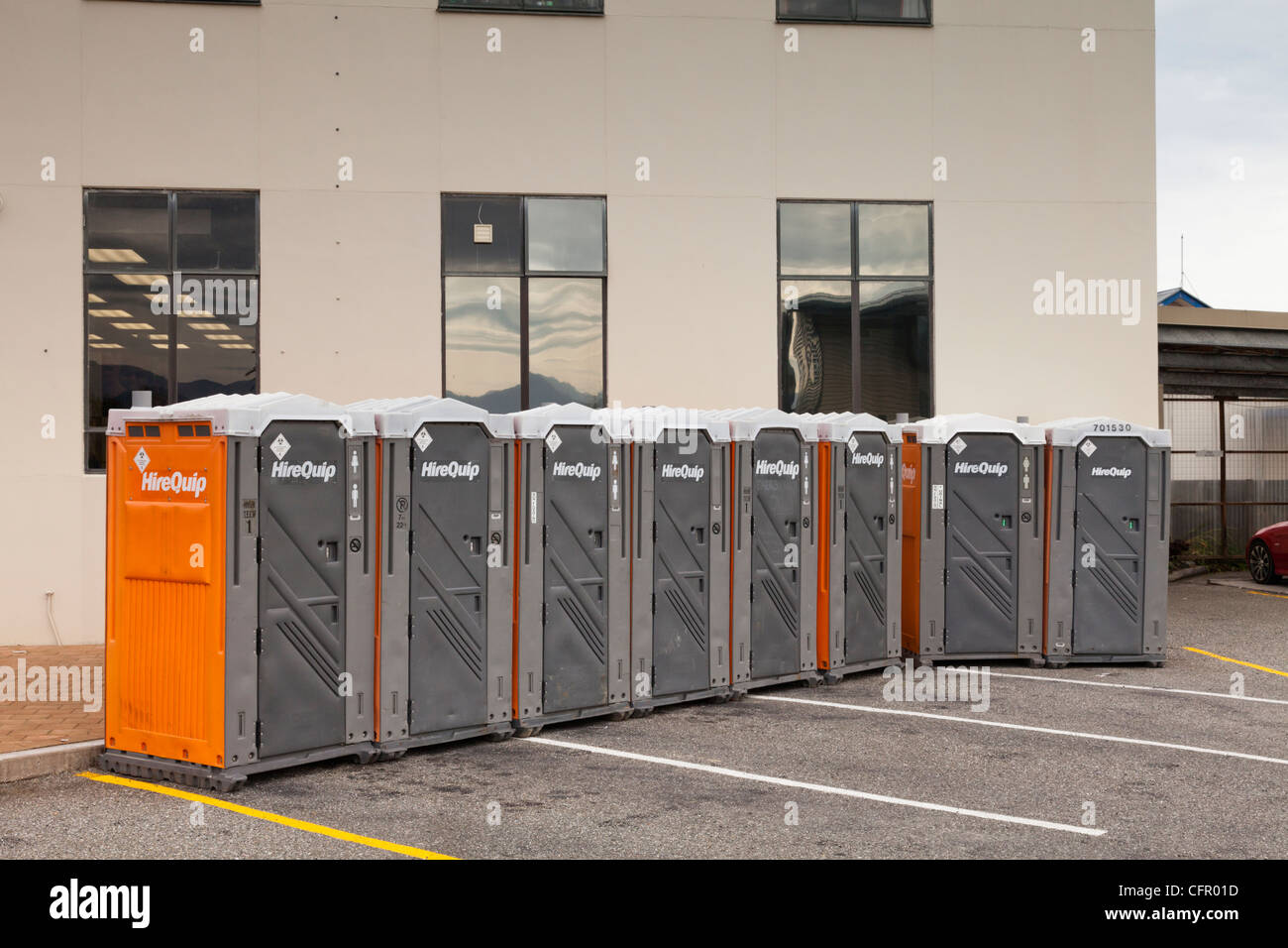 Row of HireQuip portable toilets in a car park in Hokitika, set up for the Wild Food Festival 2012 Stock Photo