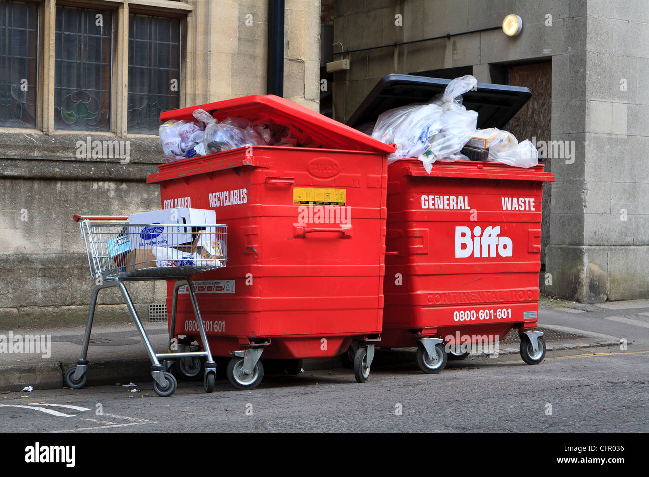 Overflowing waste bins and shopping trolley UK Stock Photo Alamy
