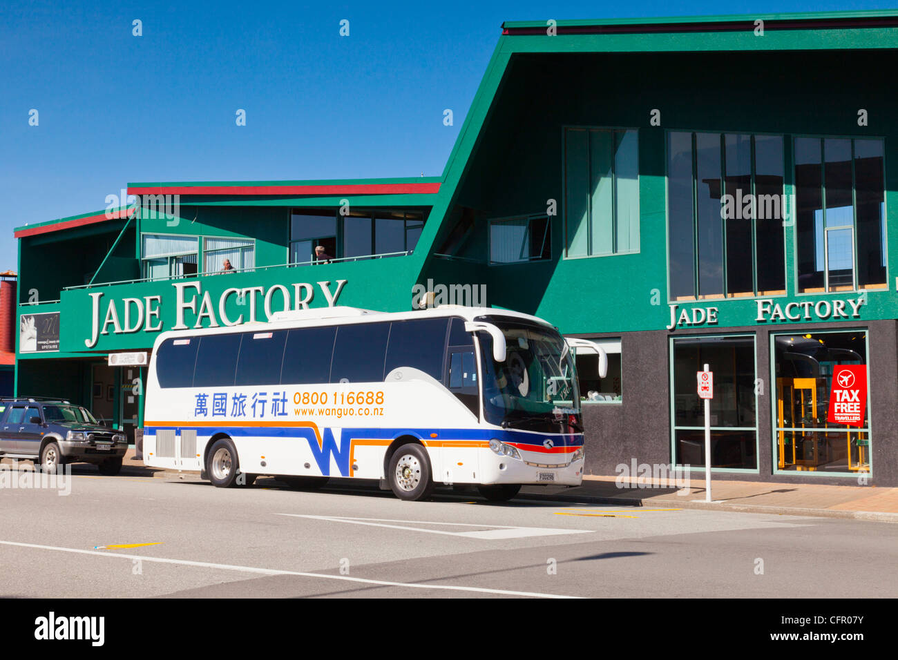 Hokitika, West Coast, New Zealand, the Jade Factory with a Chinese sign-written coach outside Stock Photo