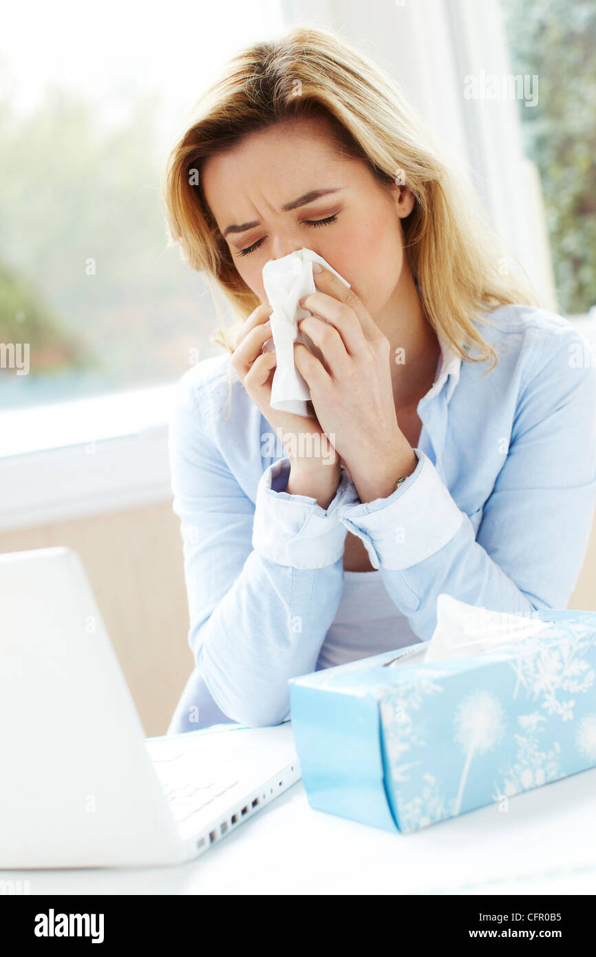 Girl with cold blowing nose Stock Photo
