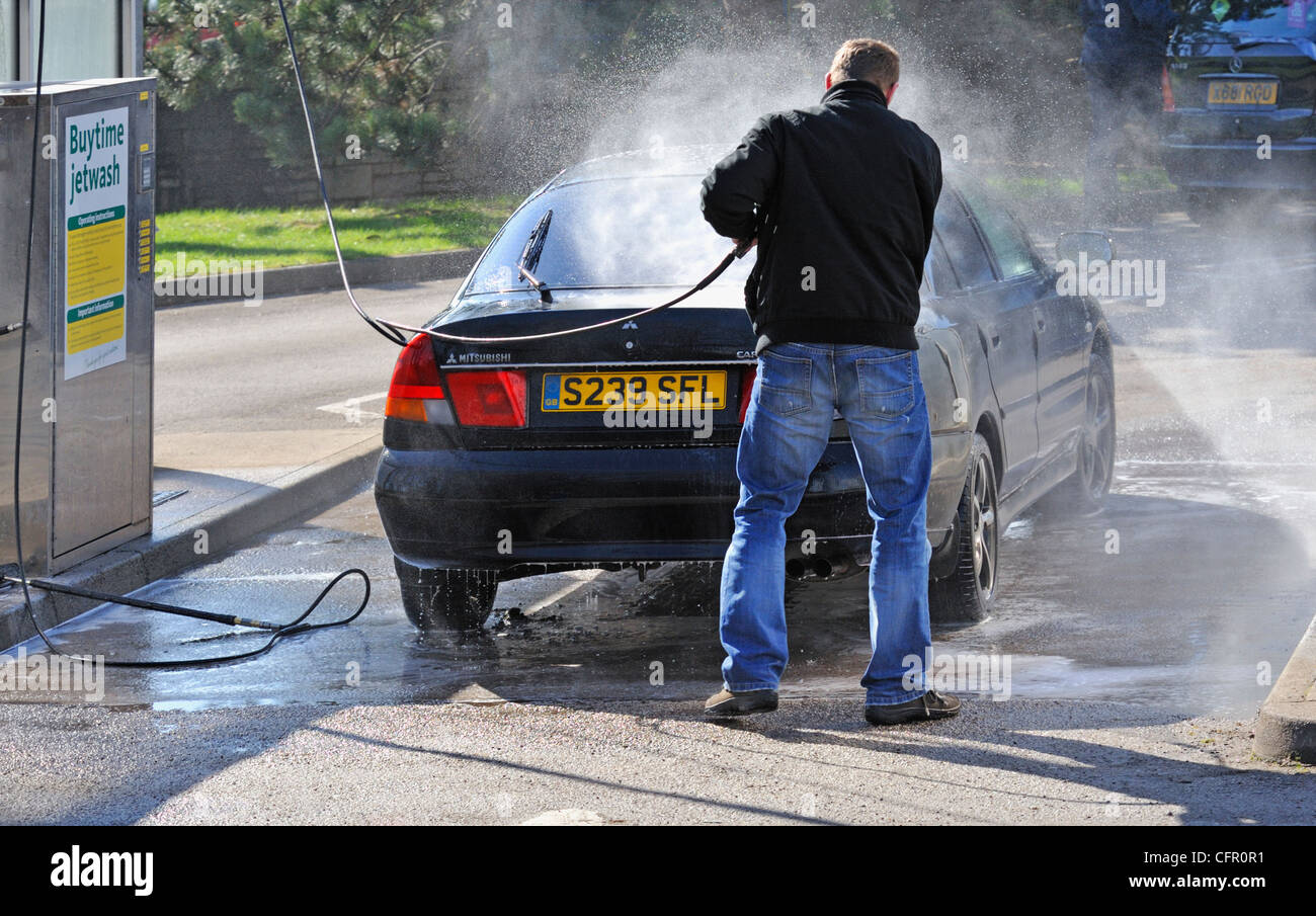 Male motorists using manual car wash. Morrisons Supermarket, Kendal