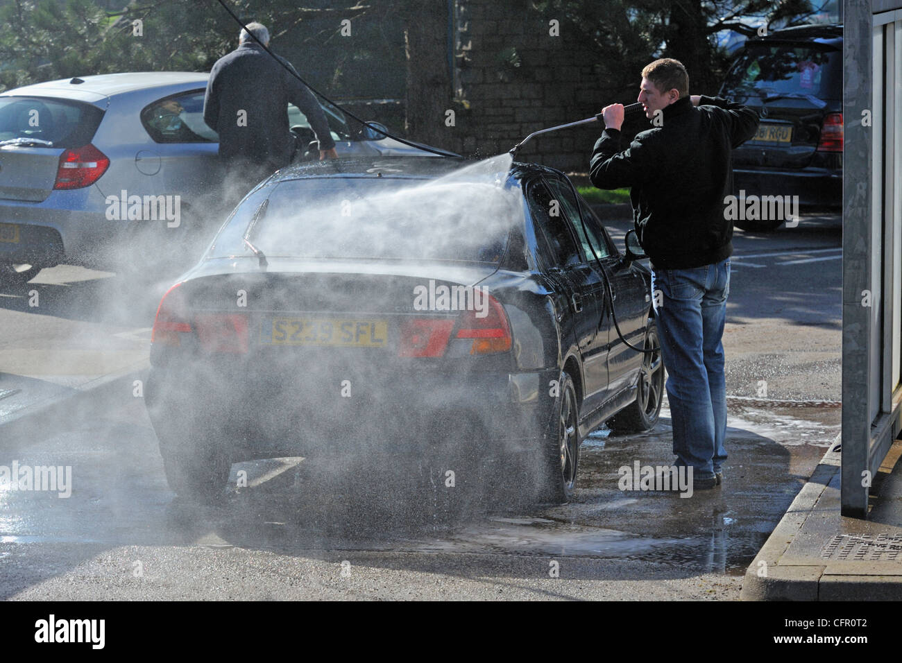 Male motorists using manual car wash. Morrisons Supermarket, Kendal