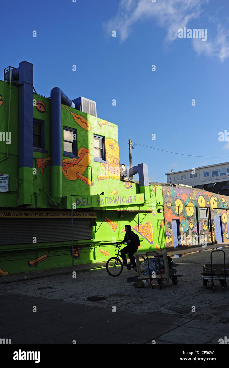 USA Southern California Los Angeles Venice Beach L.A. CA man on bicycle by deli building early morning Stock Photo