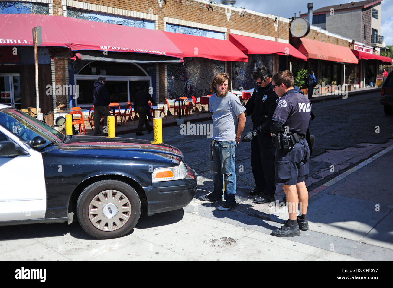 USA Southern California Los Angeles Venice Beach man being arrested along the ocean front walk Stock Photo