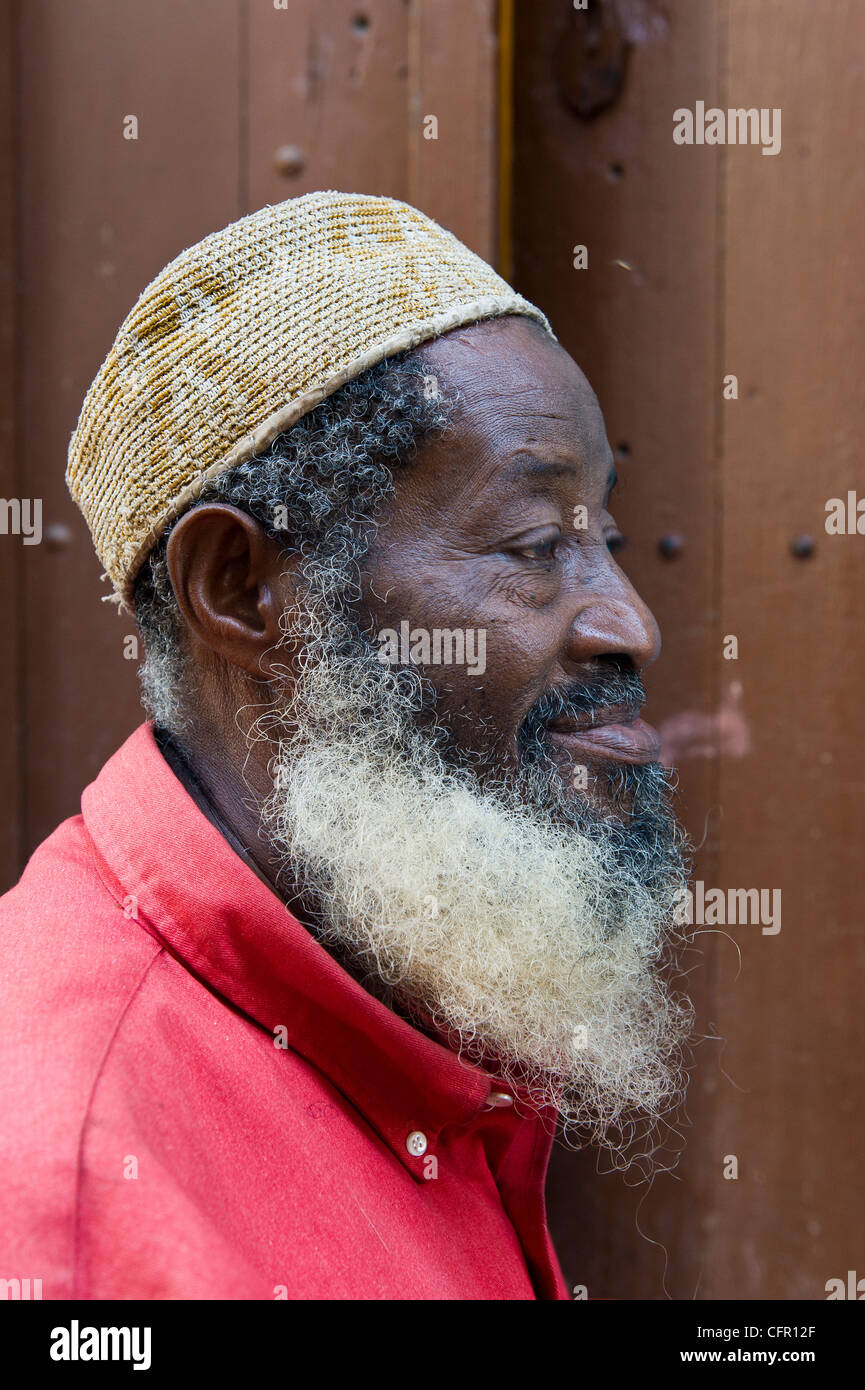 Man with beard waring a 'Kofia' in Stone Town Zanzibar Tanzania Stock Photo
