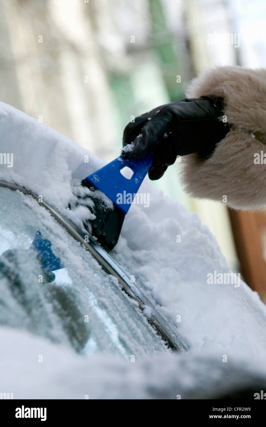 Woman Cleaning Snow Off Car Stock Photo Alamy