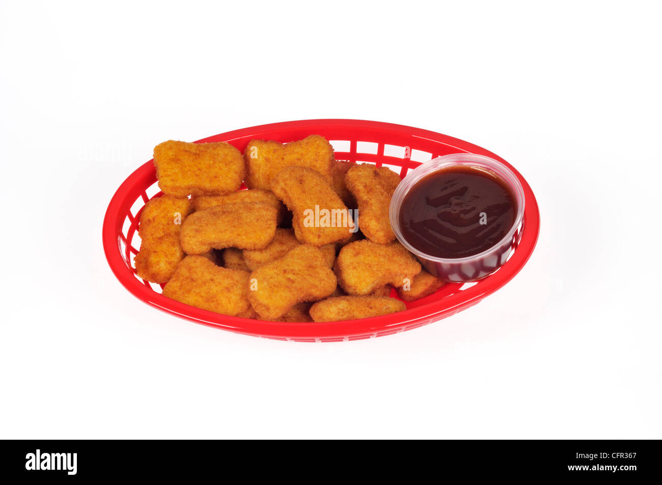 Chicken nuggets with honey barbeque dipping sauce in plastic basket Stock Photo