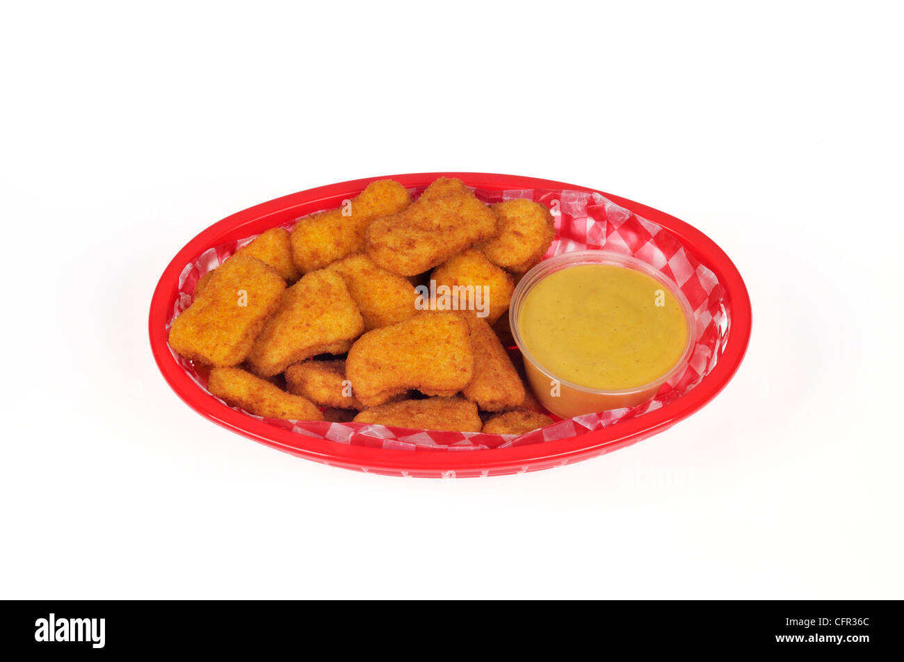 Chicken nuggets with honey mustard dipping sauce in plastic basket Stock Photo