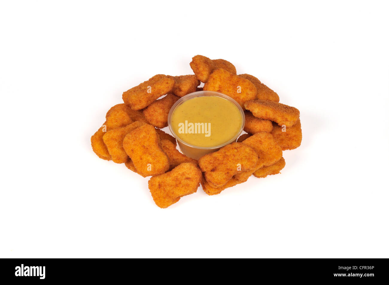 Breaded chicken nuggets around a container of honey mustard dipping sauce on white background cut out. Stock Photo