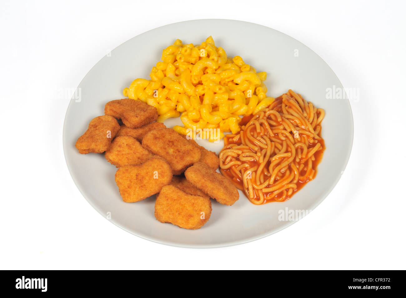 Breaded chicken nuggets, spaghetti with tomato sauce and macaroni and cheese on white plate on white background cut out. Stock Photo