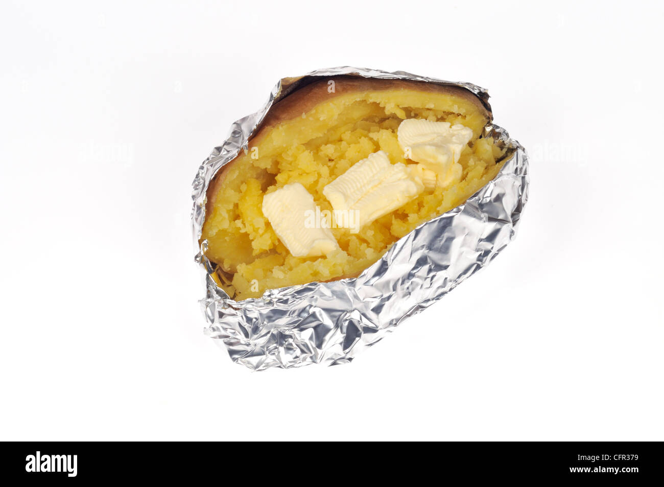 Cooked baked jacket yukon gold potato cut in half with melting butter wrapped in tin foil on white background cut out Stock Photo