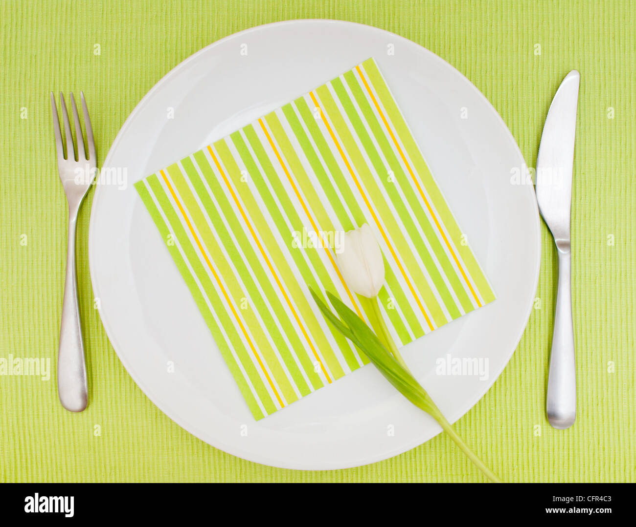 Set Table With Fork, Knife and Tulip on White Plate Stock Photo - Alamy