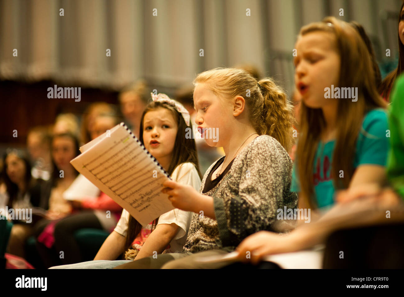 The 'Only Kids Aloud' welsh children's choir rehearsing Mahler's 8th Symphony at Aberystwyth Arts Centre, Wales UK Stock Photo