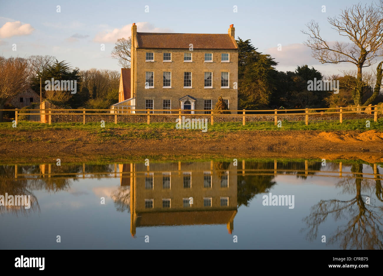 farmhouse reflected in pond water Bawdsey, Suffolk, England