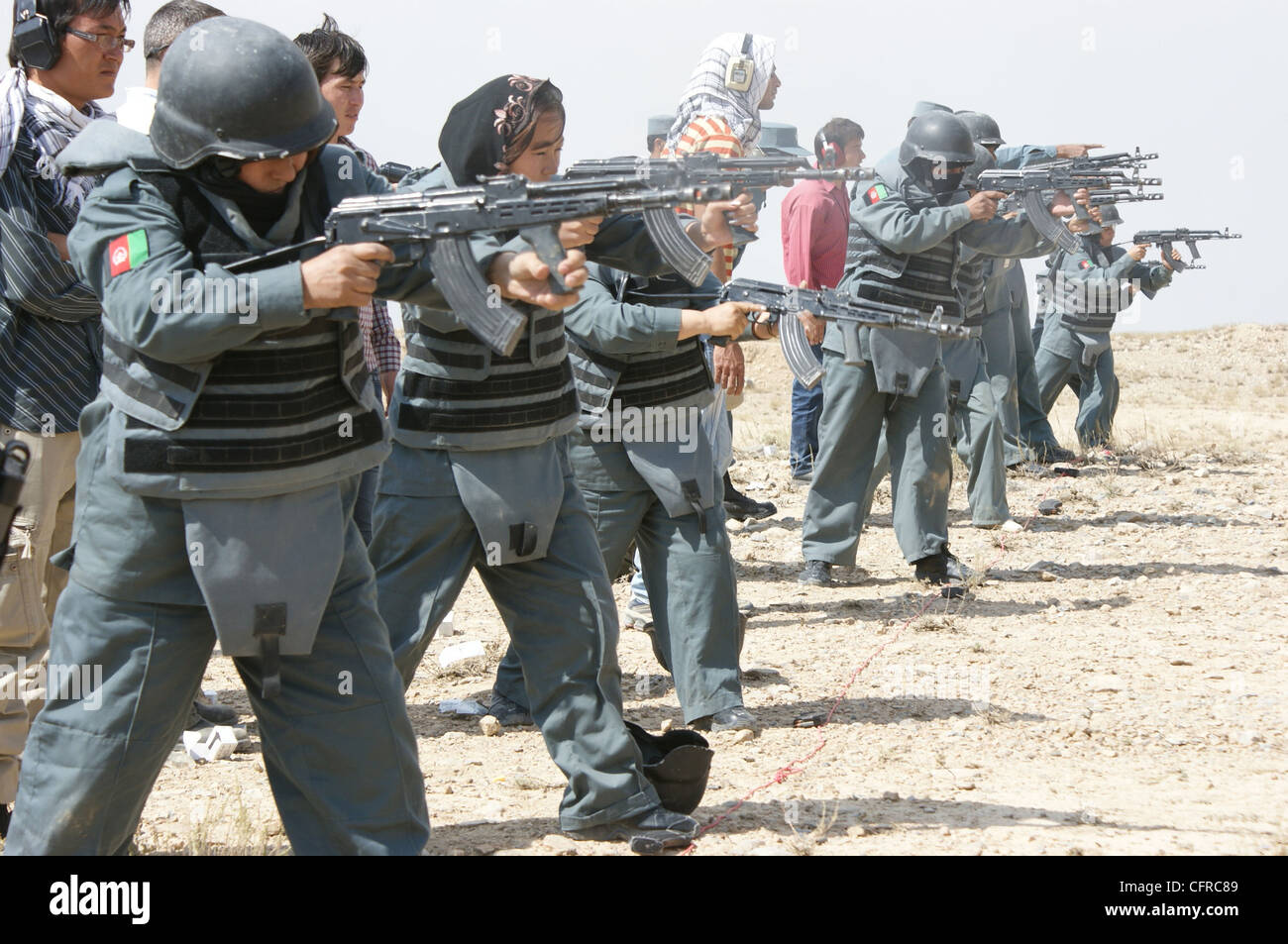 Female Afghan National Police recruits learn how to fire an AMD-65, a Hungarian version of the AK-47, during an eight-week basic police training course at the Central Training Center July 10, 2010 in Kabul, Afghanistan. Stock Photo