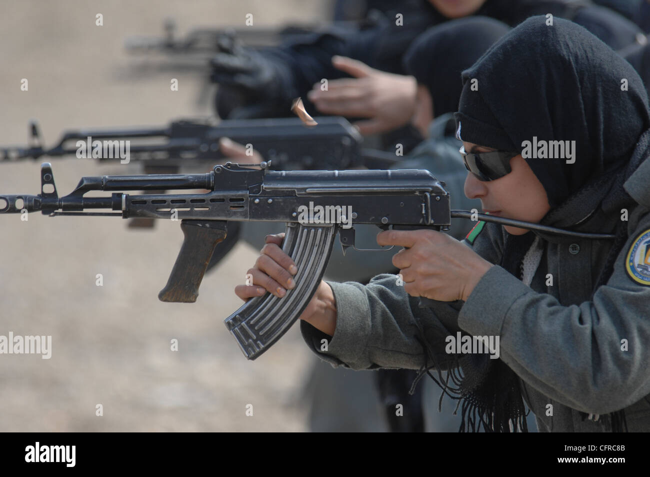 Female Afghan National Police recruits learn how to fire an AMD-65, a Hungarian version of the AK-47, during an eight-week basic police training course at the Central Training Center July 10, 2010 in Kabul, Afghanistan. Stock Photo