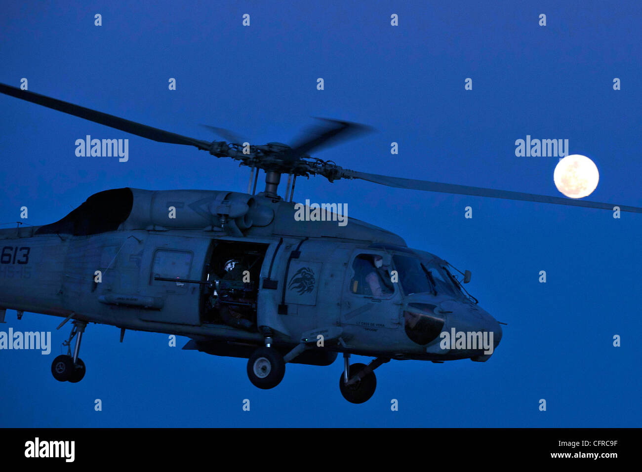 A US Navy Sea Hawk helicopter launches from the flight deck of the