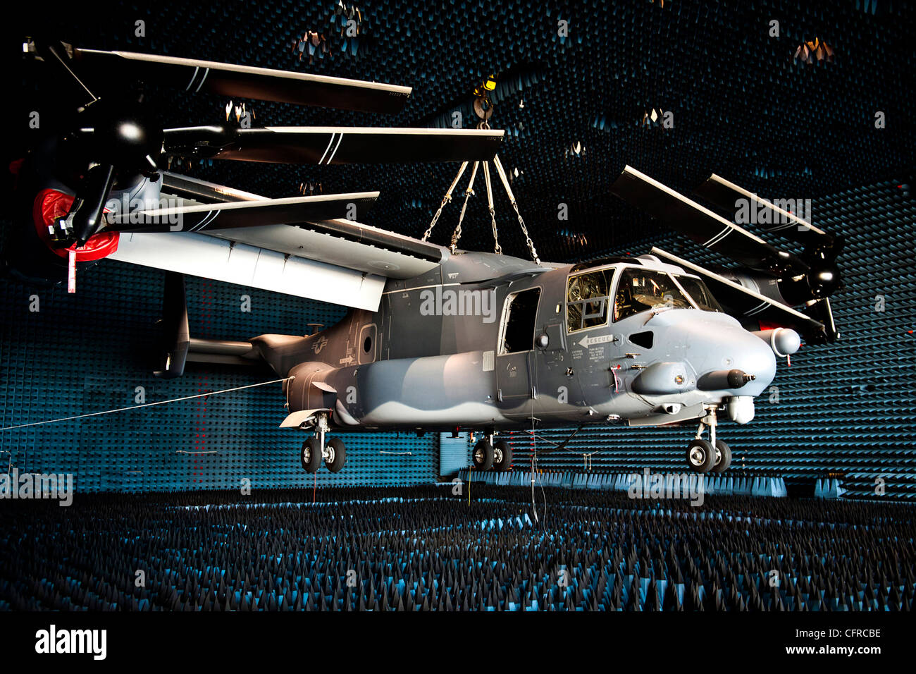 A CV22 Osprey vertical lift aircraft hangs in the anechoic chamber at