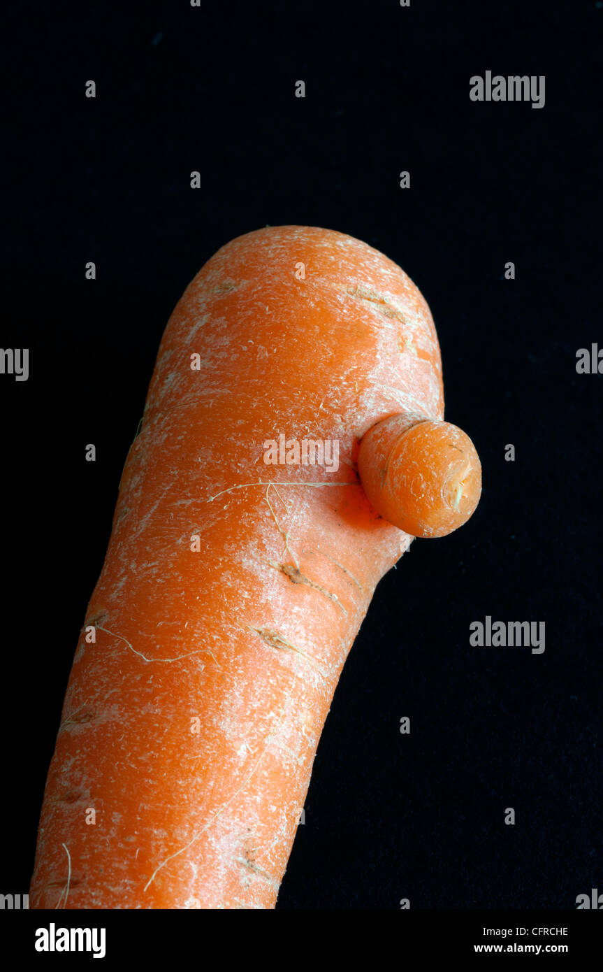 A carrot with a nose-like growth Stock Photo