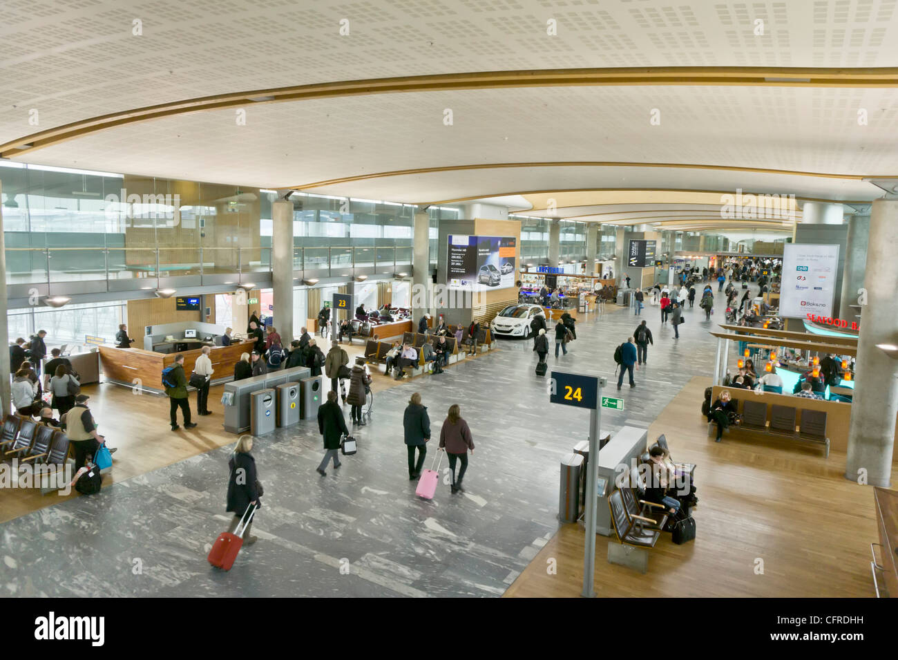 Airline passengers walking through departure lounge hall at Oslo Airport Norway Europe Stock Photo