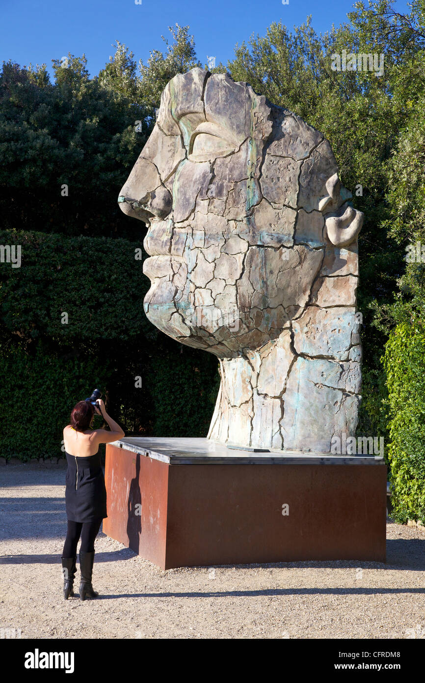 Young woman taking photograph of the Monumental Head, by Igor Mitora, Boboli Gardens, Florence, Tuscany, Italy, Europe Stock Photo